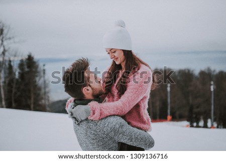 Smiling couple in snowy field