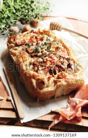 tasty homemade quiche with parma ham, cheese and figs