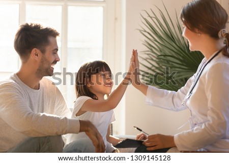 Healthy happy child girl giving high five to female caring doctor celebrate good checkup medical result recovery visiting pediatrist in hospital, pediatrician with kid patient good relationship trust Royalty-Free Stock Photo #1309145128