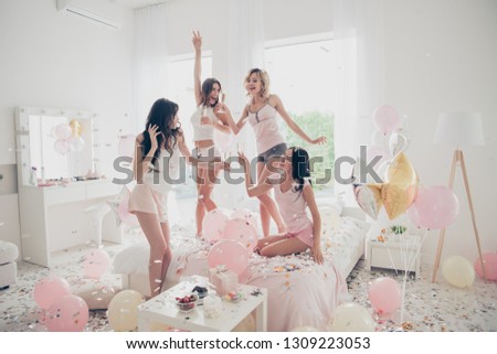 Nice-looking cool crazy careless carefree attractive feminine fit thin slim graceful cheerful funny girlfriends having fun showing v-sign in light white interior decorated house