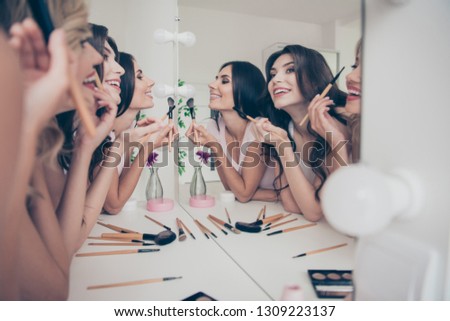 Portrait of nice cute winsome attractive lovely well-groomed glamorous shine cheerful girlfriends having fun blush blusher in light white interior decorated house indoors