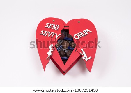 Red gift on box with chocolate writes I LOVE YOU white lettering for special Valentine's Day gift pack stands on white background Buy chocolate in different angles. 
