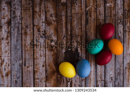 
colored eggs on a wooden background