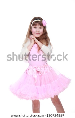 Ukrainian beautiful little girl with long healthy hair in a pink tutu