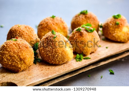  Home made Arancini. Italian fried rice balls with mozzarella and fresh parsley Royalty-Free Stock Photo #1309270948