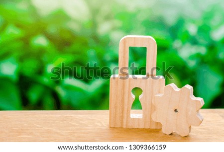 Wooden padlock and gear. Conceptual strength and security mechanisms and critical nodes. Protection against unauthorized access, insurance and security of production and components. Selective focus