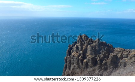 Black lava rock in front of blue sea on the island of Lanzarote