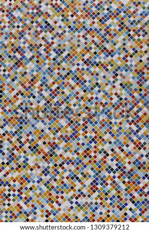 in the photo there is a background with a colorful mosaic of ceramic tiles. Mosaic of different colors, but each tile is the same shape and size