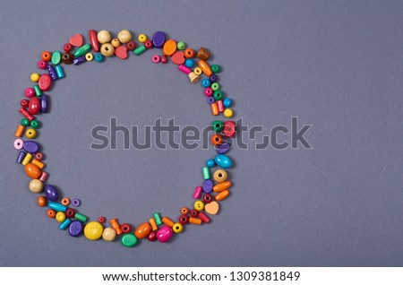 Wooden color beads composition. Needlework concept background. Flat lay and top view photo