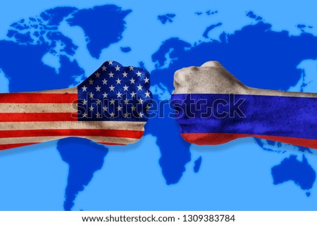 Governments conflict concept. Male fists colored in USA and Russian flags on world map background. Conflict between USA and Russia