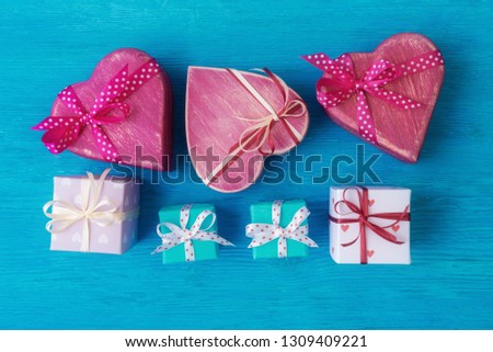 Top view of various gift boxes over blue wooden background