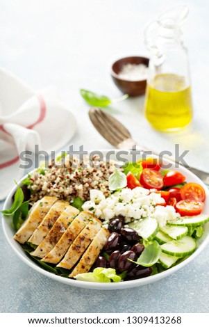 Greek inspired lunch bowl with chicken, quinoa, feta cheese and olives