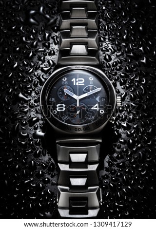 Wristwatch on black background.