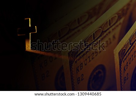 Cross with light shafts and dollars. Faith symbol.