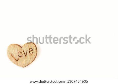 Natural wooden hearts with an inscription love on a white isolated background