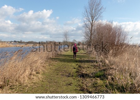 Person hiking with a backpack in a beautiful natural landscape on a sunny day