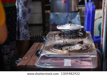 fresh boiling food in stainless steel pan on hot gas fueled stove, prepared for frying breakfast meal food in indoor kitchen background. Kitchen utensils, Cooking tools and equipment design concept.