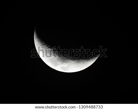 Crescent moon background / The Moon as it appears early in its first quarter or late in its last quarter, when only a small arc-shaped section of the visible portion is illuminated by the Sun