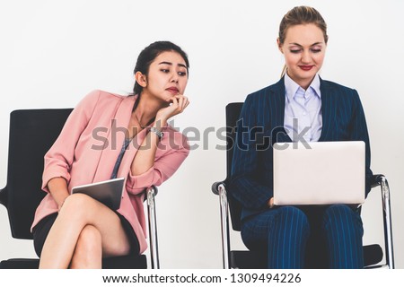 Curious businesswoman looking at the screen of laptop computer of another businesswoman spying stealing idea and copying private information from coworker at workplace. Plagiarism concept. Royalty-Free Stock Photo #1309494226