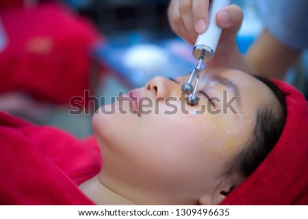 Spa Series: Young Beautiful Woman Having Various Facial Treatment by focusing around the eyes.