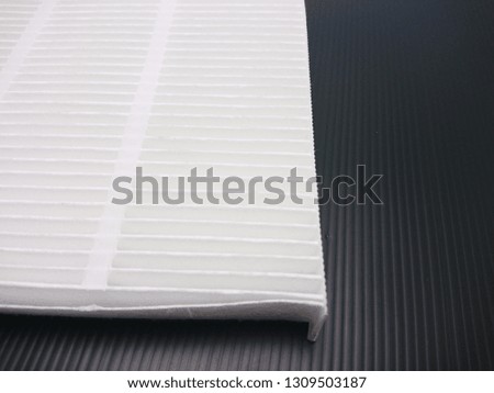 New automotive cabin air filter isolated on black background