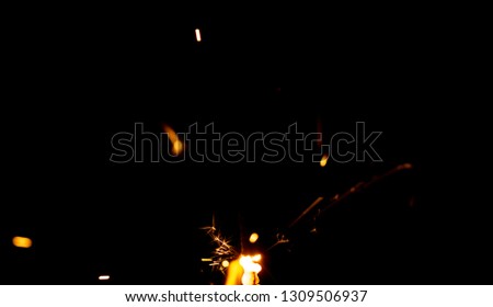 Sparks of fire on a black background welding fireworks.