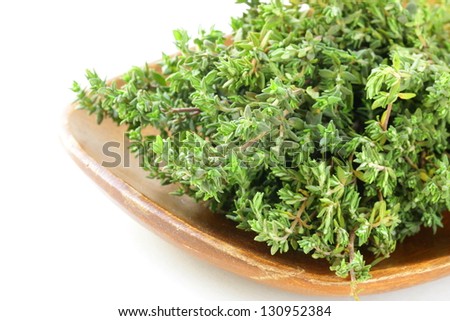  bunch of organic thyme on a wooden plate