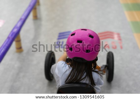Cute Child girl are driving car toy in the playground