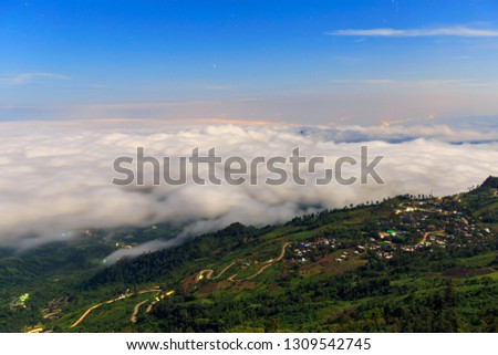 Picture of a mountain top from above the clouds