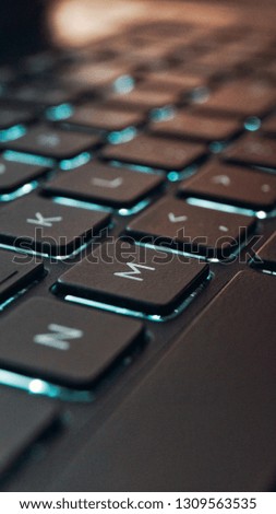 Laptop Keyboard with teal lights