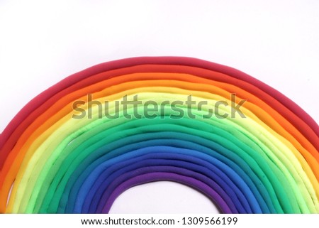 Rainbow made of plasticine on a white sheet of paper