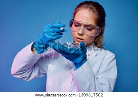    laboratory assistant woman in glasses conducts experiments chemicals                            