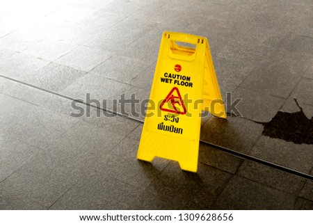 Yellow plastic caution wet floor sign