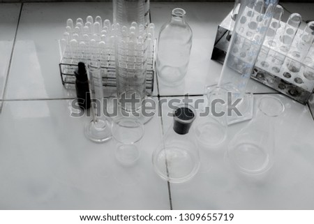 Science class in laboratory with working tools, glass and flasks on black and white picture.