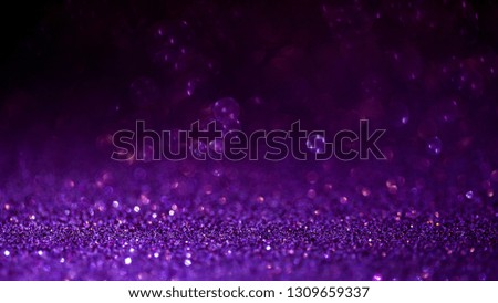 Purple glitter magic background. Defocused light and free focused place for your design. Abstract background