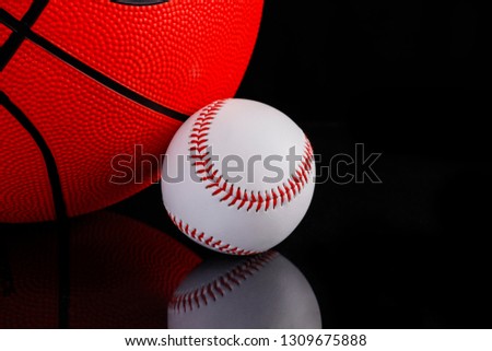 Basketball and baseball on black background 