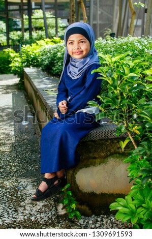 Smiling asian muslim child with hijab
