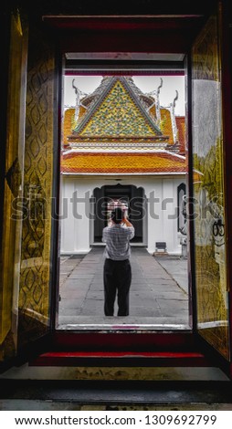 Tourist take a photo of Thai temple architecture