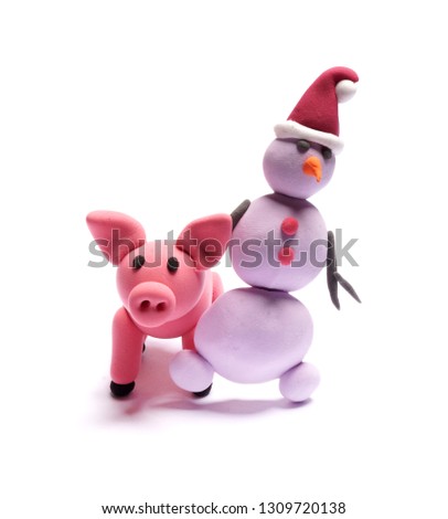 Cute pink pig and snowmen of plasticine on a white background
