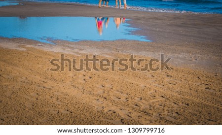 A photo of a having a perfect walk on the Racó beach by the Mediterranean Sea on a beautiful sunny day. The photo features Cullera, which is a touristic seaside town in Valencia, Spain, Europe