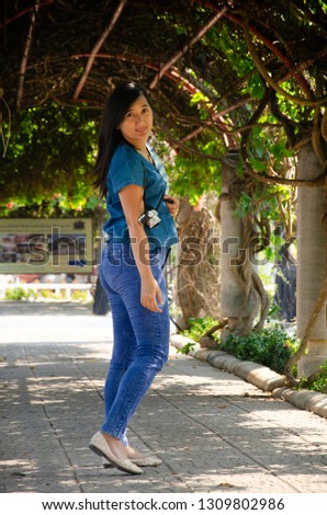 Asia thai woman travel visit and standing posing for take photo in public garden park in Sing Buri , Thailand