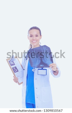 Young female doctor looking at the x-ray picture isolated on white background. Woman doctor
