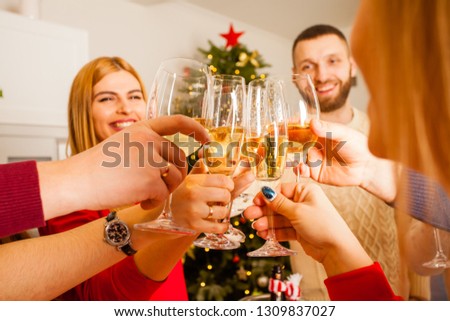 Group of friends celebrating New Year with champagne in their hands