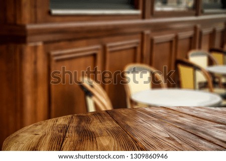 Table background of free space for your decoration and wooden blurred background of wall and chairs 
