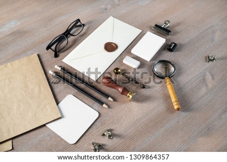 Photo of blank vintage stationery on wooden background.