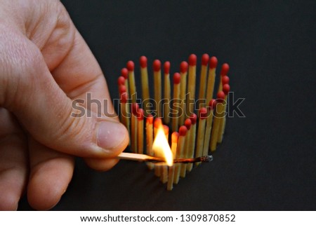 Set a heart made out of matches on fire - Abstract konzept for setting a heart on fire - Symbol for love and feelings