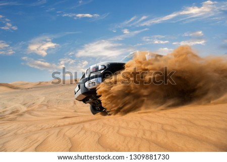 Freeze motion of four wheel drive through the desert in the United Arab Emirates. Royalty-Free Stock Photo #1309881730