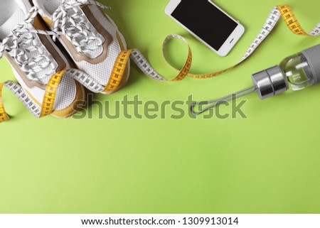 Flat lay composition with fitness gym equipment on color background. Space for text