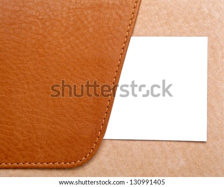 Sample business card in open leather holder isolated on white background