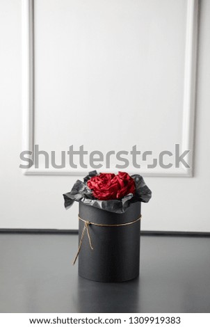Romantic luxury red rose in a black gift box with space for logo on a gray background studio,studio photography,spring is coming,international women's day